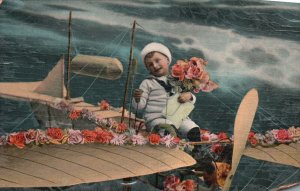 Little Boy in Flying Airplane, Flowers Greetings & Wishes Card Vintage Postcard