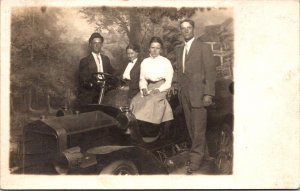 Real Photo Postcard 1911 Two Couples with an Automobile in a Photo Studio