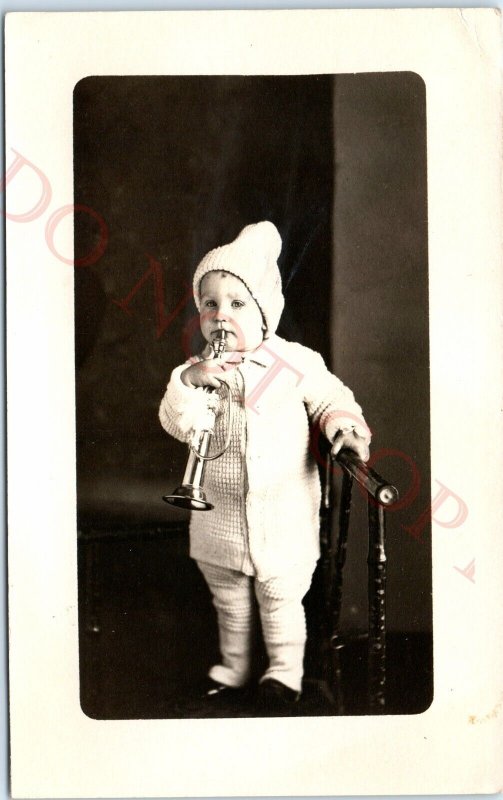 c1910s Adorable Baby w/ Trumpet RPPC Winter Cap Cute Musical Kid Real Photo A143