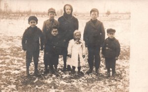 Vintage Postcard Young Children in Winter Clothes Snow in Field Portrait RPPC