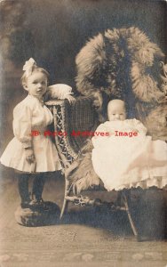 Studio Shot, RPPC, Two Children with Wicker Chair and Fur Blanket