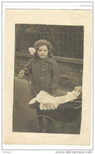 RP; Girl standing next to baby buggie with doll inside, 10-20s