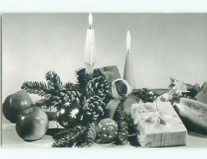 Old rppc CHRISTMAS SCENE - CANDLES AND PRESENTS & PINE CONES o2646