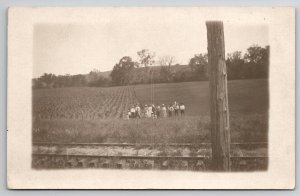 Towns People Posing in Corn Field with Railroad Track RPPC Postcard D28