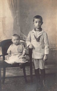 YOUNG BOY & BABY-IDENTIFIED AS SCHREILER & DORETTE~REAL PHOTO POSTCARD