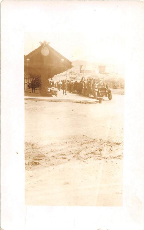 SOLDIER & CIVILIANS OPEN AIR CAR RAILROAD STATION? REAL PHOTO POSTCARD 1900s