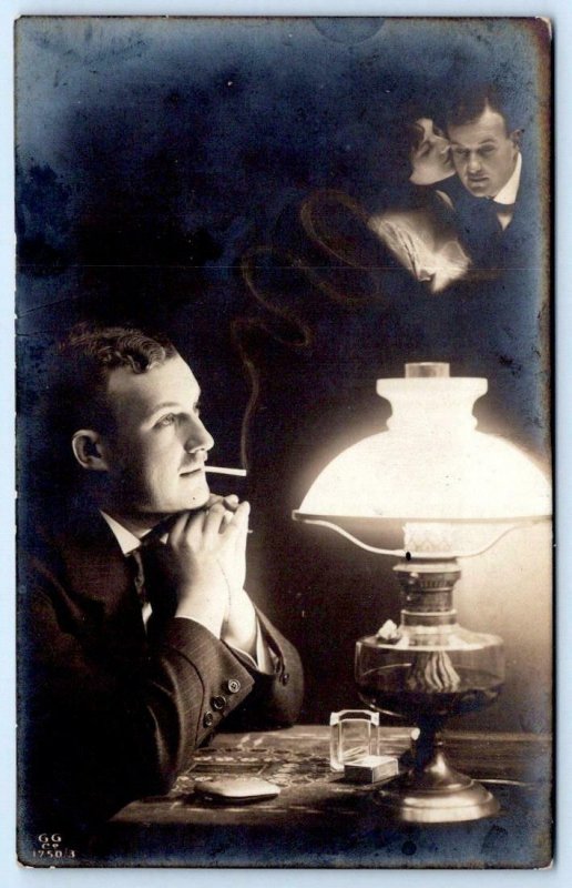 1912 RPPC MAN SMOKING A CIGARETTE AND DAYDREAMING*ROMANTIC COUPLE*OIL LAMP*CASE