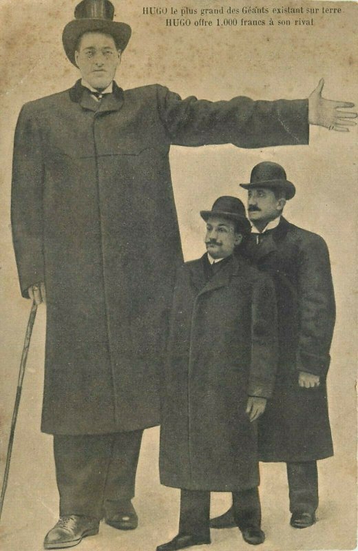 The giant Hugo offers 1000 francs to his rival tallest man world record postcard