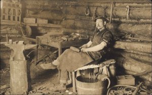 Blacksmith in Shop Anvil Hammer in Hand Horseshoes Real Photo Postcard