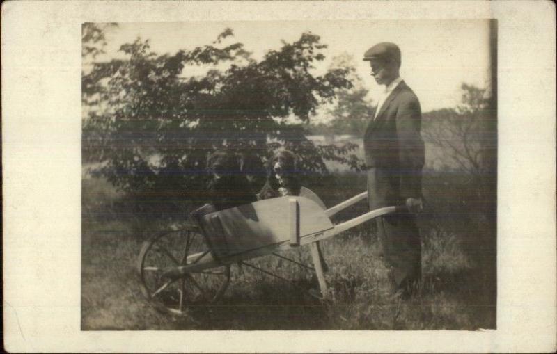 Man w/ Dogs in Wheelbarrow c1910 Real Photo Postcard - Black Lab?