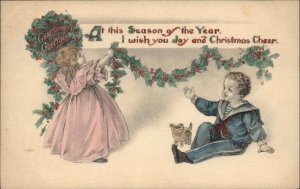 Christmas Little Boy and Girl Hang Holiday Decorations c1910 Vintage Postcard