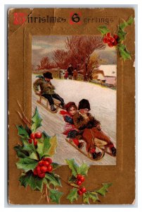 Christmas Greetings Children Sledding Holly Gilt Embossed DB Postcard O18