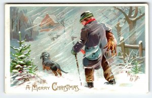 Christmas Postcard Dog Man Blowing Wind Snow Cane 1907 Tuck Series 102