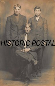 THREE BROTHERS ? POSING AT DIFFERENT TIMES-LOT OF 2 REAL PHOTO POSTCARDS
