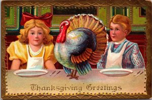 Thanksgiving Greetings Postcard Boy and Girl with Live Turkey at Dinner Table