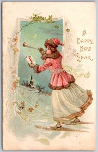 1910s A HAPPY NEW YEAR Embossed Postcard Lady Horn Snow Shoes Winter Scene