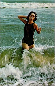 Girl in Black Bathing Suit running in ocean postcard