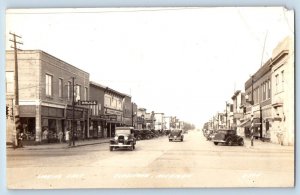 Gladstone Michigan MI Postcard RPPC Photo Looking East Drugs Store Radio's Cars