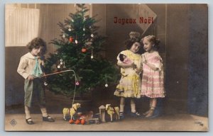 Christmas Xmas Joyeux Noel Postcard - Young Children With Tree Presents  c1920