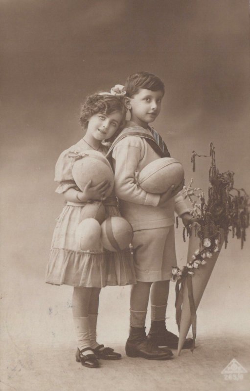 RPPC Postcard Children Fancy Clothes Holding Giant Easter eggs