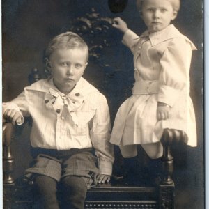 c1910s Cute Siblings RPPC Cute Children Little Boy Girl Wood Chair Postcard A167