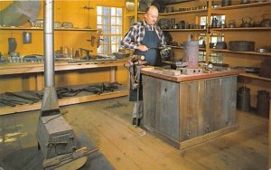 The tinsmith at work in his shop Sturbridge, Massachusetts  