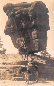 Women riding mules on trail Large balancing boulder - Manitou Springs, Colora...