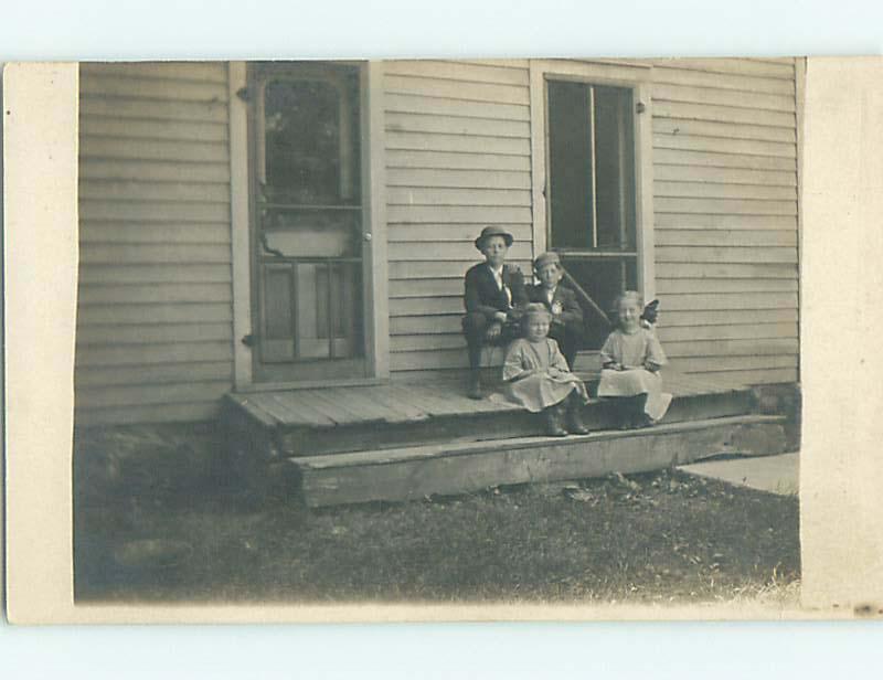 Pre-1918 rppc TWO CUTE GIRLS WITH BOWS IN HAIR SIT ON PORCH r5880