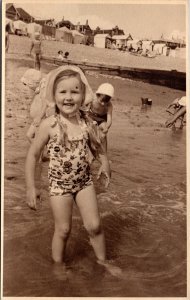 RPPC Young girl at beach blond pigtails bonnet