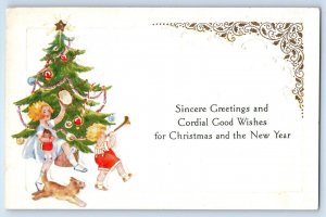 c1910s Christmas Greetings Children Playing With Doll Horn Dog Embossed Postcard