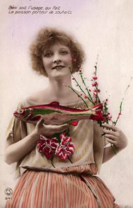 VINTAGE POSTCARD ATTRACTIVE WOMAN ON COLOR-ENHANCED FISH AND FLOWERS MAILED 1924