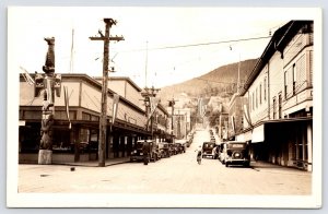 Ketchikan Alaska~Main St Decorated w/US Flags & Pennants~Totem Pole 1920s RPPC