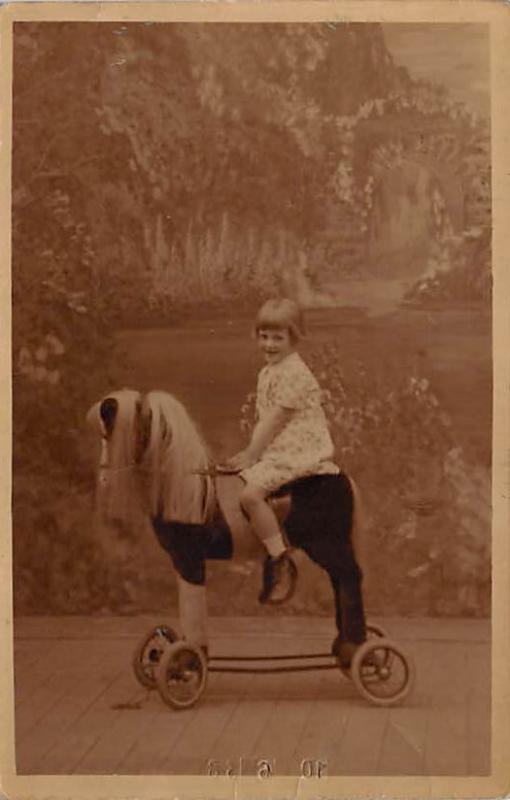 Child on toy horse Child, People Photo Unused 