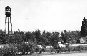 East Tawas Michigan~State Park~Man by RV Camper~Water Tower~Lake Huron~'50s RPPC