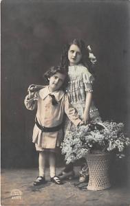 2 Young children with flowers R & K Child, People Photo Writing on back 