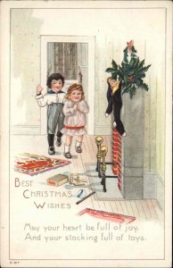 Christmas  Children Find Stockings with Toys c1910 Vintage Postcard