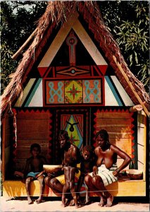 VINTAGE CONTINENTAL SIZE POSTCARD INDIGENOUS FAMILY SITTING OUTSIDE HUT SURINAM