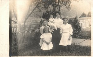 Vintage Postcard 1910's RPPC Family Photo in Front of Fence Mom & Daughters