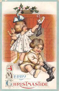 A Merry Christmastide children with stockings fireplace antique pc Z16783