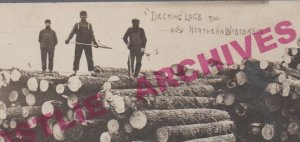 Wausau WISCONSIN RPPC 1925 LOGGING SCENE Lumberjacks DECKING LOGS Colby Photo WI