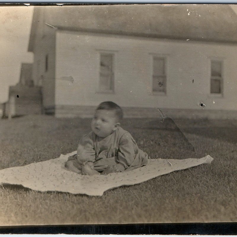 c1910s Cute Baby Outdoors RPPC Blanket House Yard Play Real Photo Postcard A173