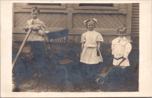 Real Photo Postcard Three Children Outside Wooden Wheelbarrow Push Mower