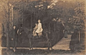 CHILDREN SITTING ON HORSE-REAL PHOTO POSTCARD 1910s