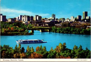 VINTAGE CONTINENTAL SIZE POSTCARD M.S. RIVER ROUGE & SKYLINE OF WINNIPEG CANADA