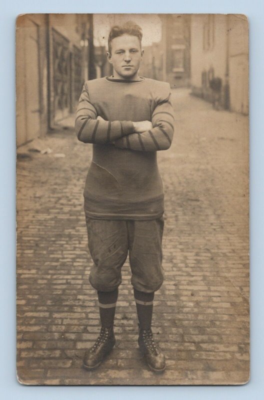 Early 1900s American Football Player Arms Crossed on Brick Road Sepia RPPC