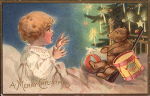 Christmas Little Boy Surprised by Teddy Bear and Drum Toy Gun Vintage Postcard