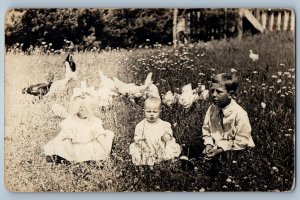 c1910's Children Baby Chicken Hen Flowers Scene Field RPPC Photo Postcard