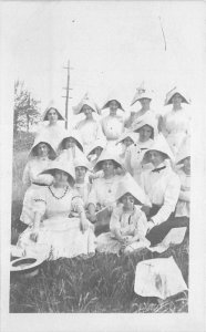 C-1910 Women Newspaper Hats RPPC Photo Postcard 21-12756