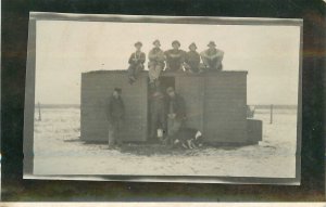 Postcard C-1910 Pioneer Life group men prairie Shack RPPC 23-12533