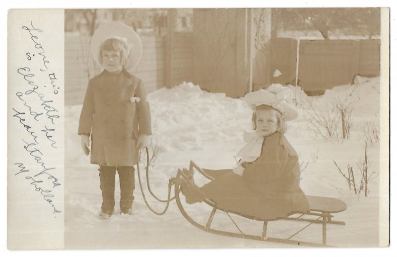 Young Boy Pulling Girl on Sled Unmailed AZO Real Photo Post Card RPPC c1908